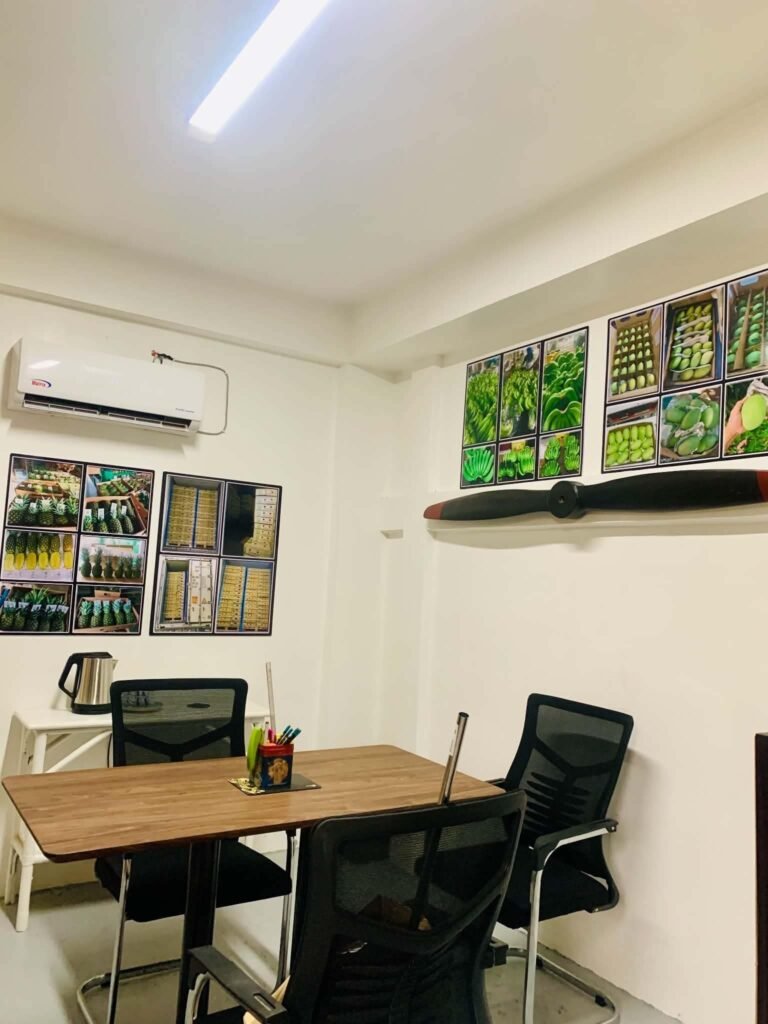 Meeting table with chairs and fruit photographs on the walls